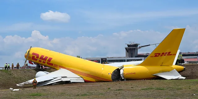 DHL cargo jet breaks into two on runway